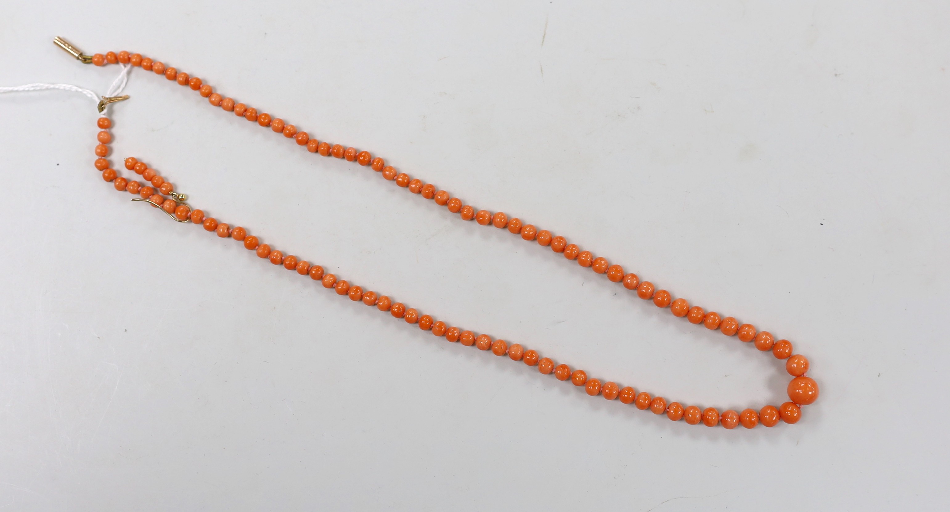 A single strand graduated coral bead necklace, with 9ct clasp, 52cm, together with a pair of coral bead earrings and a small quantity of loose coral beads.